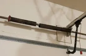 Broken torsion spring on a garage door, illustrating how much garage door springs cost to replace.